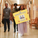 Quinta Brunson carries a poster about computers in Abbott Elementary season two